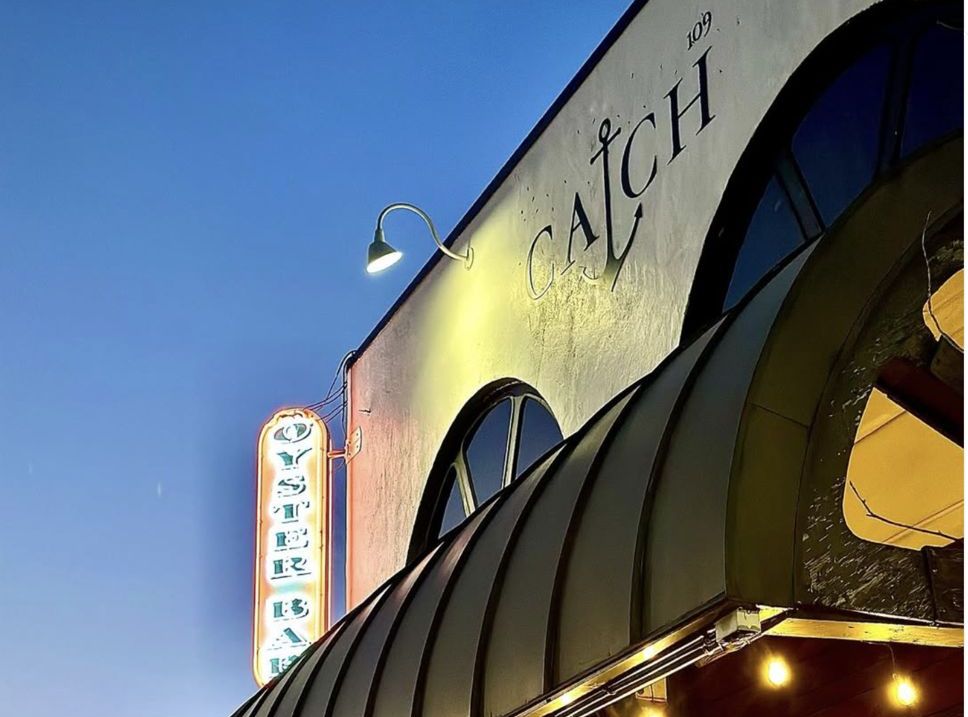 Catch 109 oyster bar storefront at dusk on S 6th Street, Morehead City NC